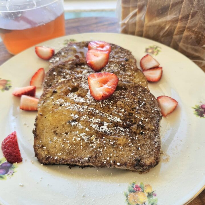 Sourdough French toast on a plate with strawberries.