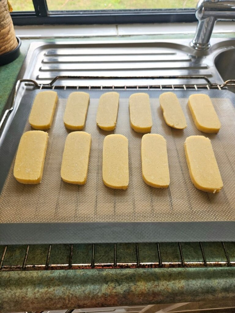 Shortbread cookies sliced on a silicon tray ready to be baked.