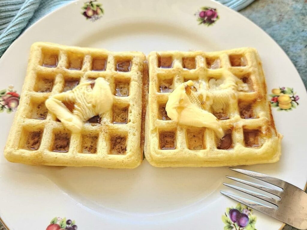 Soft and fluffy sourdough waffles on a plate. 