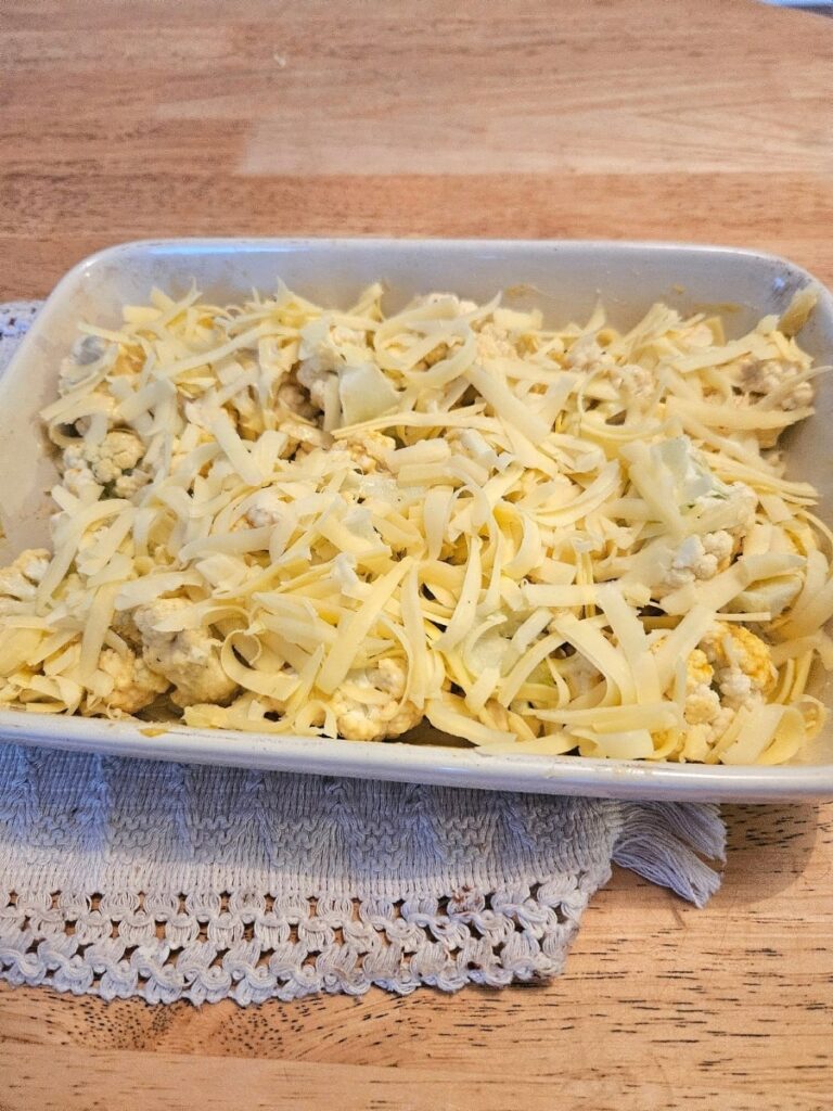 Cauliflower cheese in a tray ready for baking.