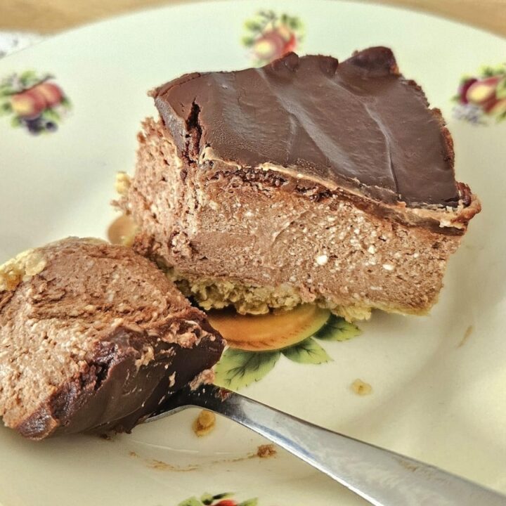 Slice of chocolate cheesecake in a bowl.