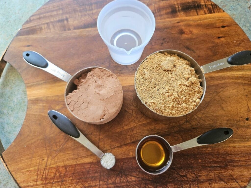 Chocolate syrup ingredients displayed on a cutting board.