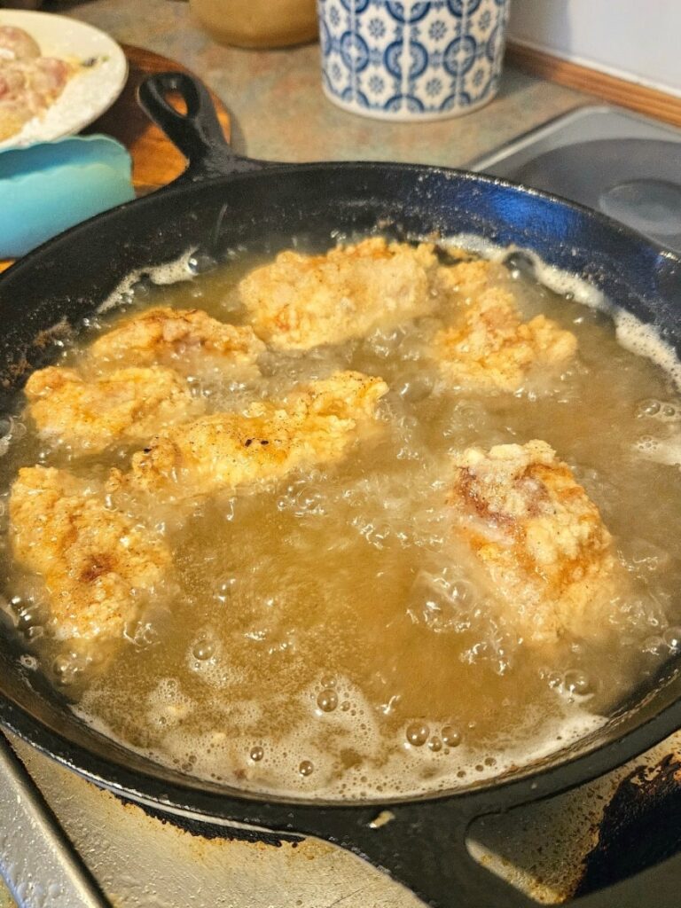 Chicken tenders frying in tallow.