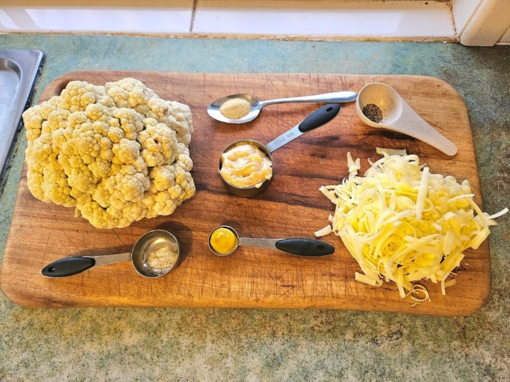 Cauliflower cheese ingredients displayed on a cutting board.