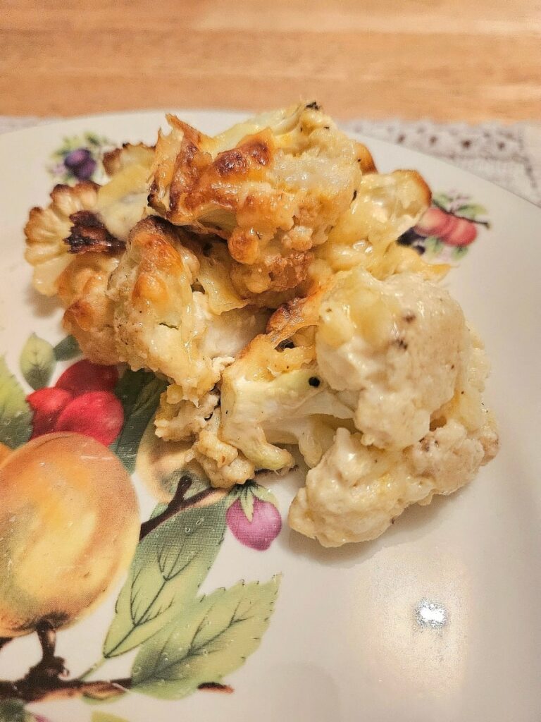 Cauliflower cheese on a plate.