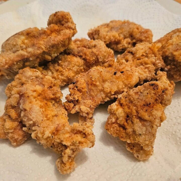 Crispy homemade gluten free chicken tenders on a plate.