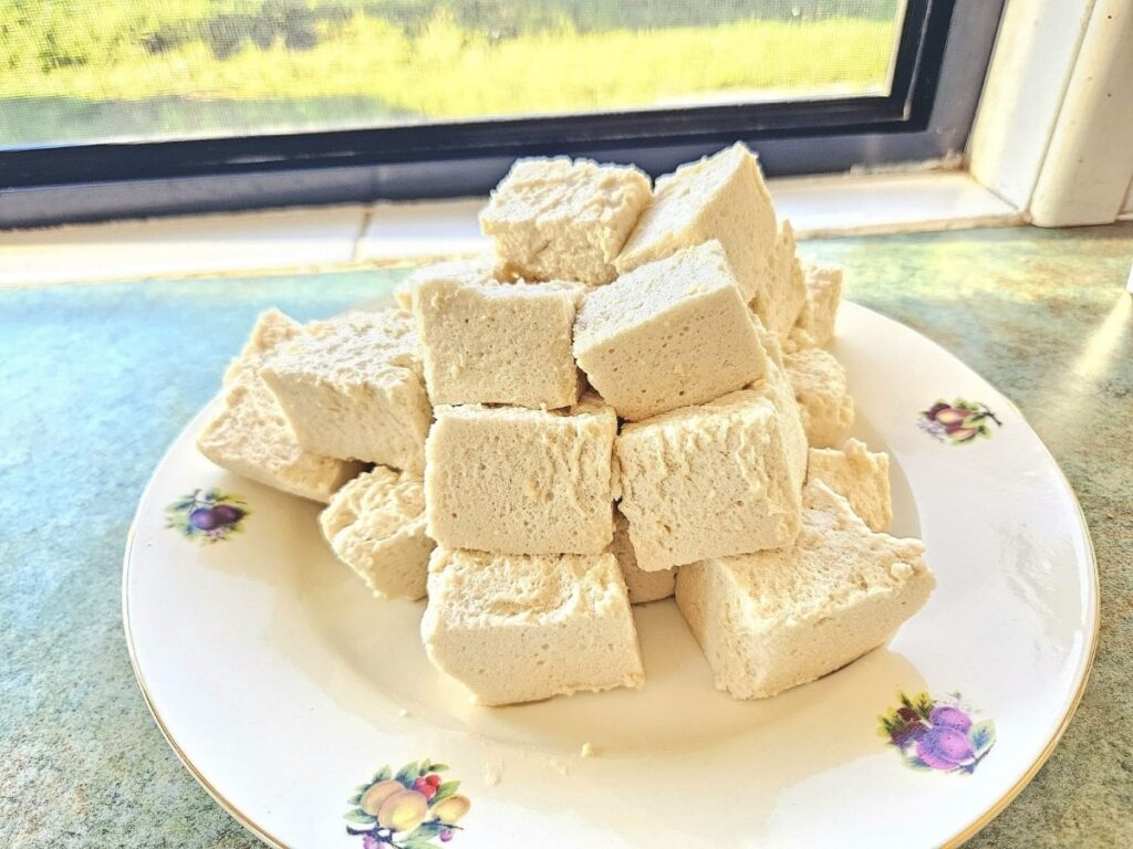 Fluffy Homemade marshmallows on a plate in the kitchen.