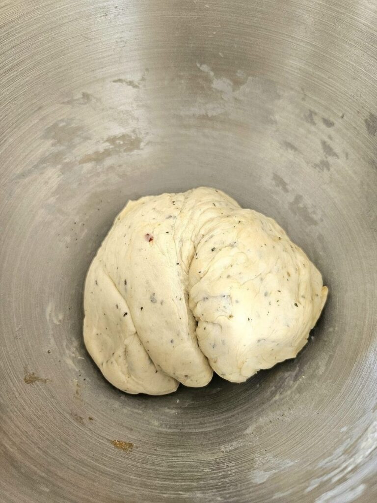 Sourdough garlic bread dough in a bowl.