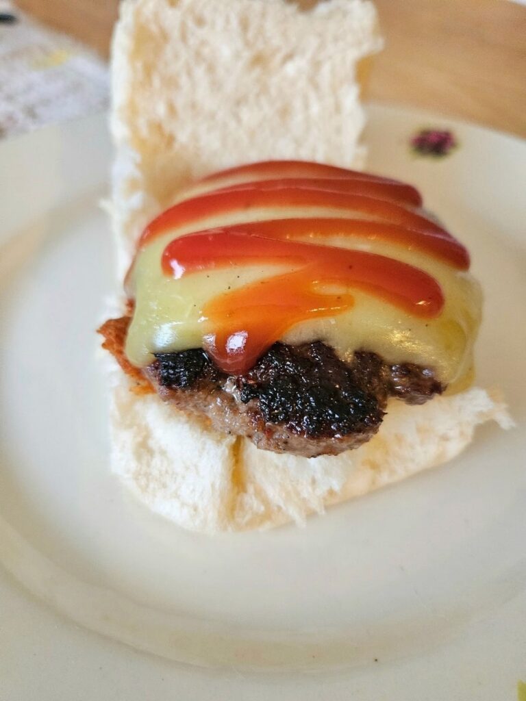 Homemade hamburger patty on a hamburger bun.