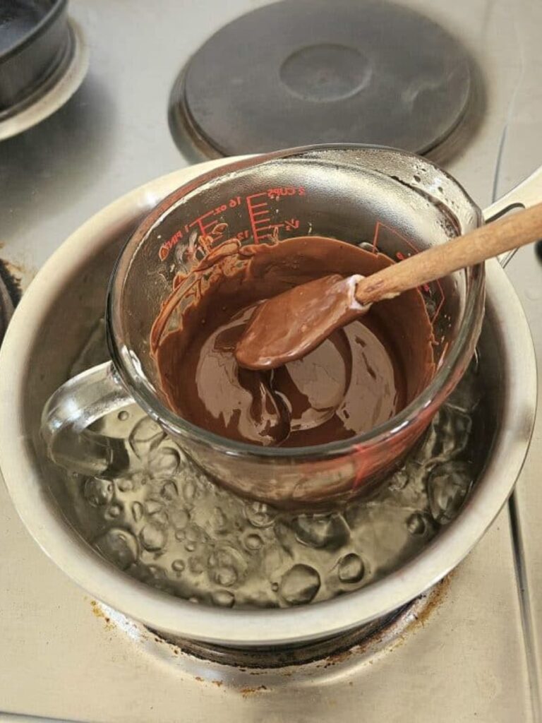 Melting dark chocolate in pot.