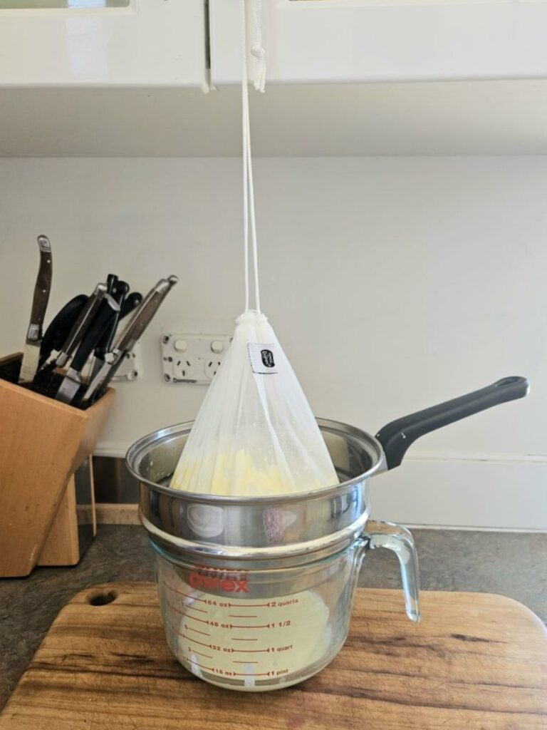 Cheesecloth hanging to strain milk kefir.