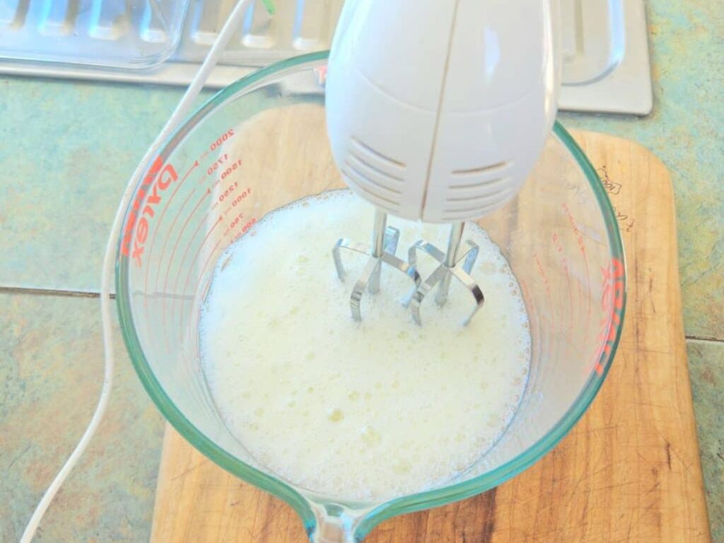 Blending egg whites in a bowl.