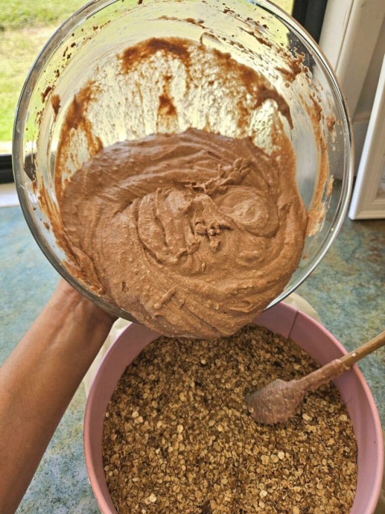 Pouring chocolate cheesecake mixture into pan.