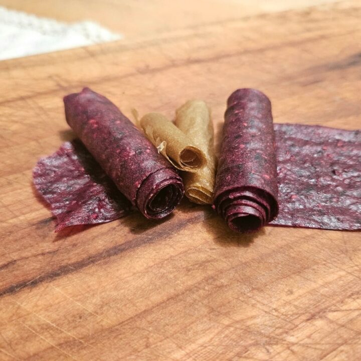 Rolled up fruit leather on a table.