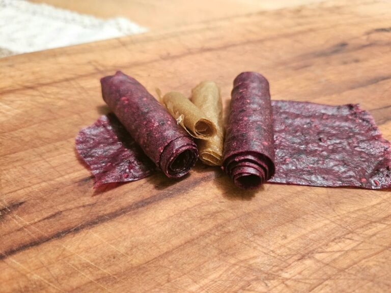 Rolled up fruit leather on a table.