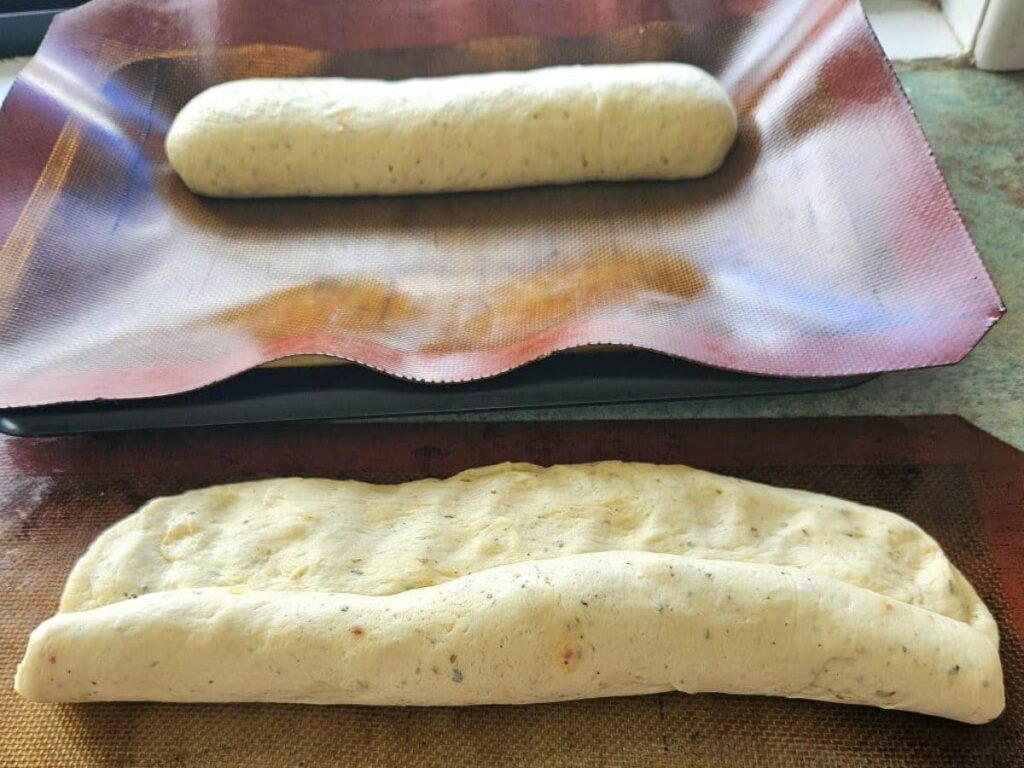 Rolling sourdough dough into French Bread.