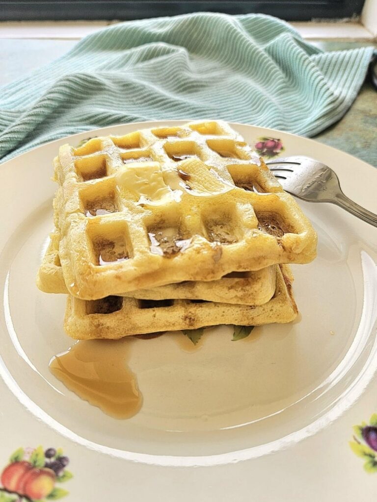 Fluffy Sourdough waffles stacked on top of each other.