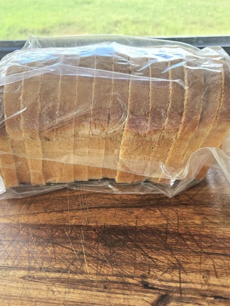 Sourdough sandwich bread sliced and sealed in a plastic bag.