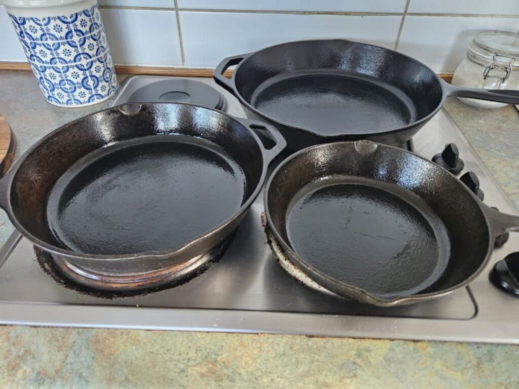 Set of cast iron Pans on the stove top.