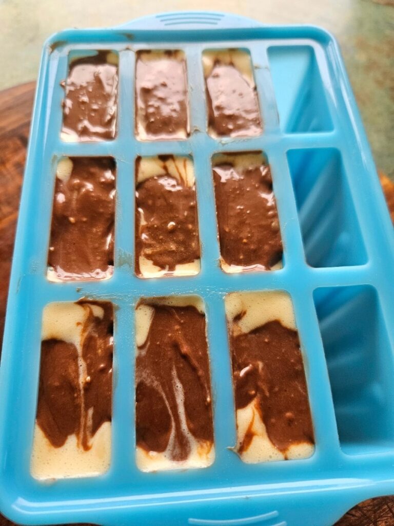 Mint chocolate popsicle batter in moulds.