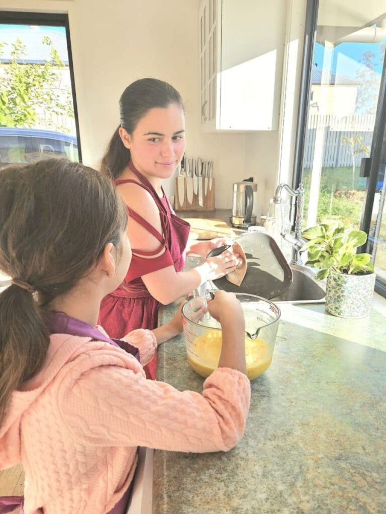 Washing dishes with kids to bond.