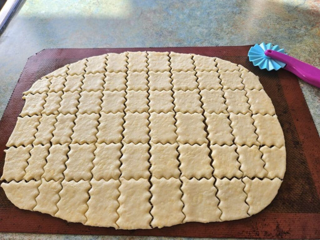 Sliced sourdough crackers ready for baking in the oven.