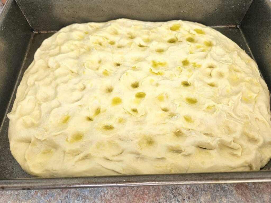 Sourdough foccacia being dimpled.