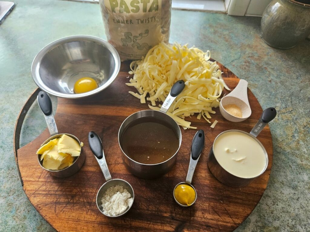 Healthy mac n cheese ingredients on a cutting board.