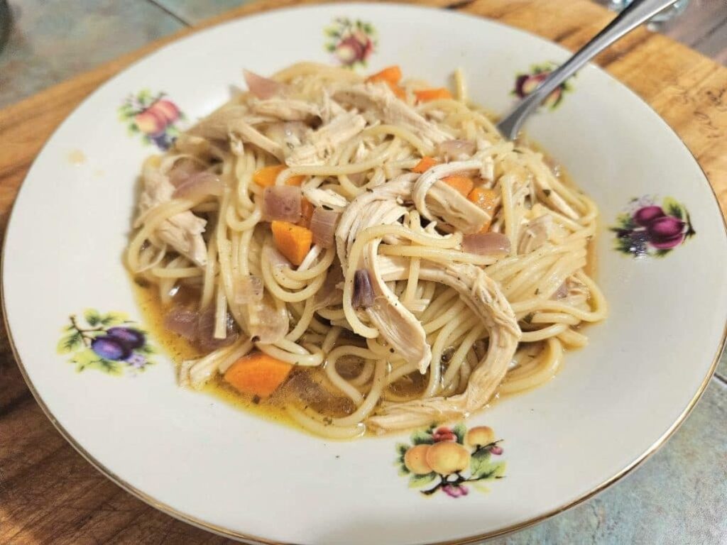 Homemade Chicken Noodle soup in a bowl on the kitchen counter.