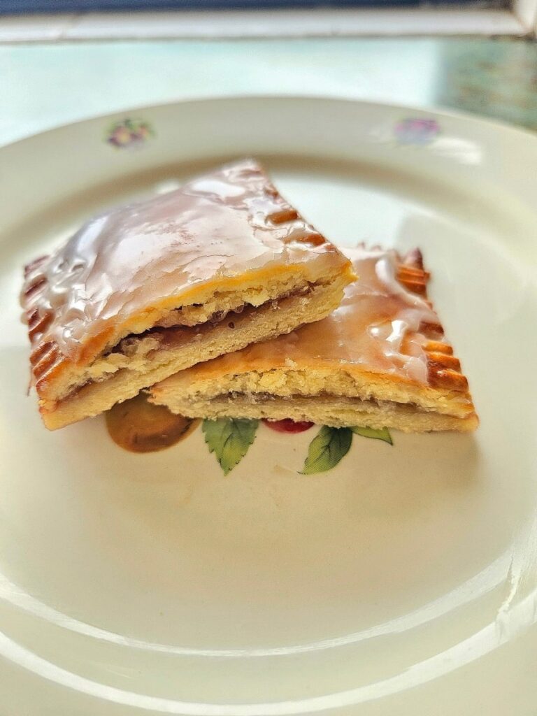 Sourdough discard pop tarts cut in half on a plate.