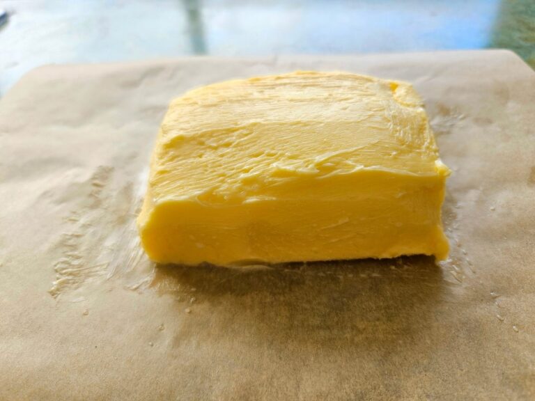 Homemade butter on wax paper being ready to be stored.