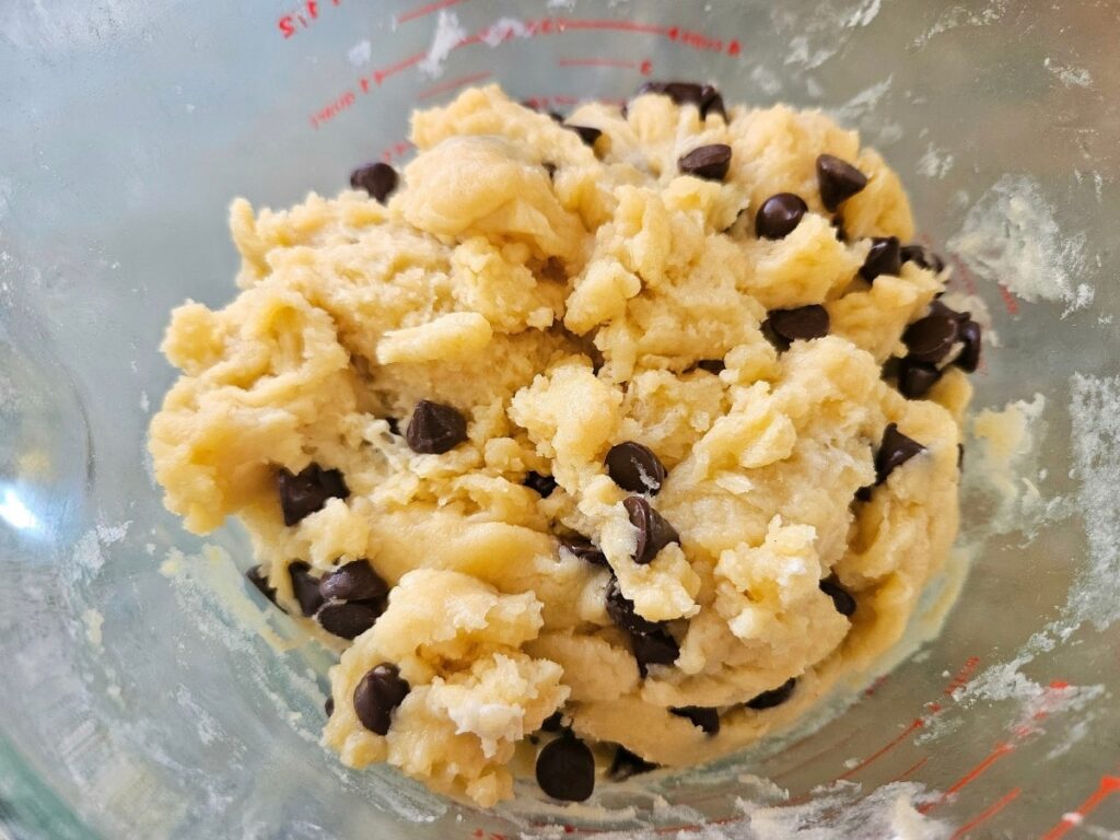 Mixing sourdough chocolate chip ingredients into a dough.