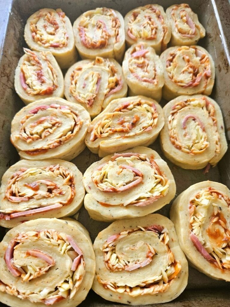 Sourdough pizza scrolls resting in a tray.