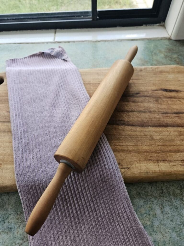 Wooden rolling pin on kitchen counter.