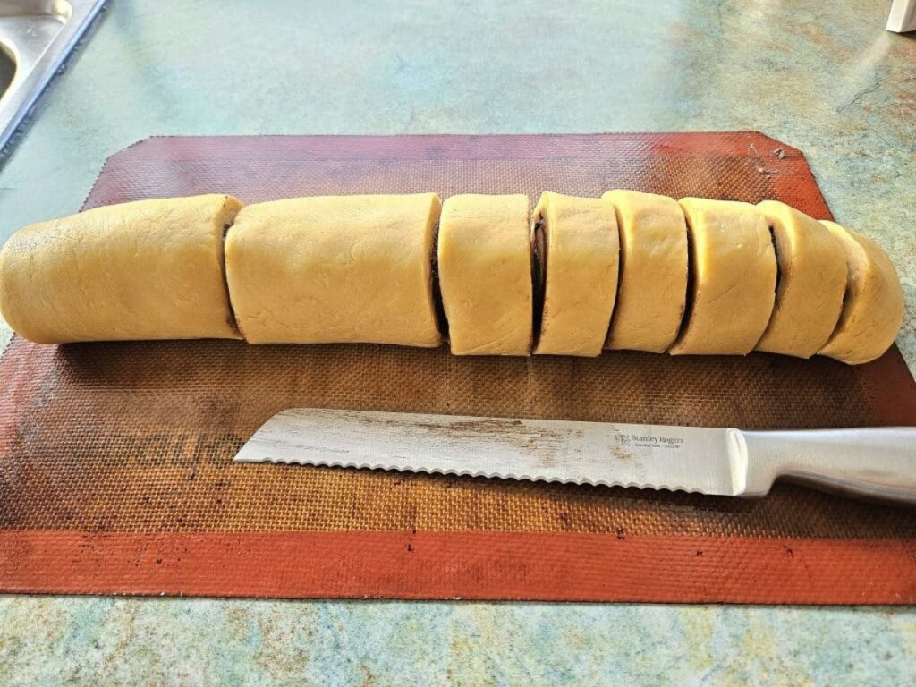 Slicing sourdough cinnamon dough into even slices