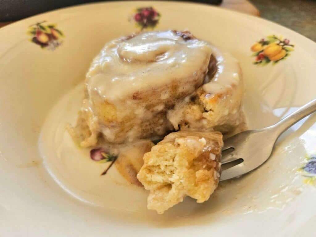 Soft homemade sourdough cinnamon roll on a plate.