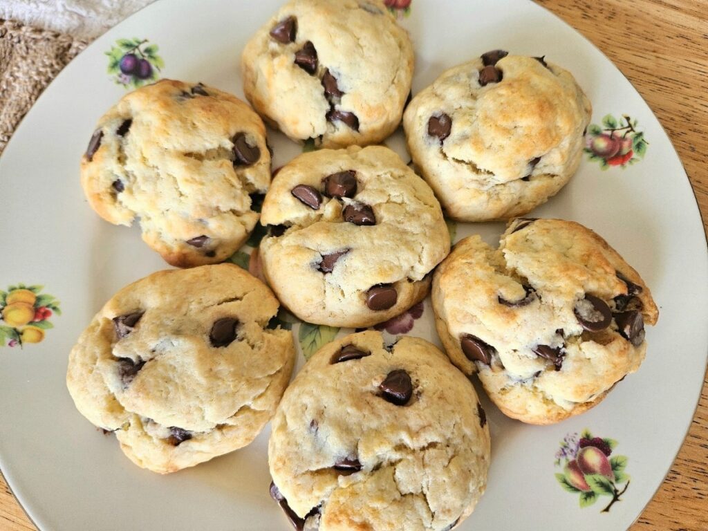 Soft sourdough chocolate chip cookies on a plate.