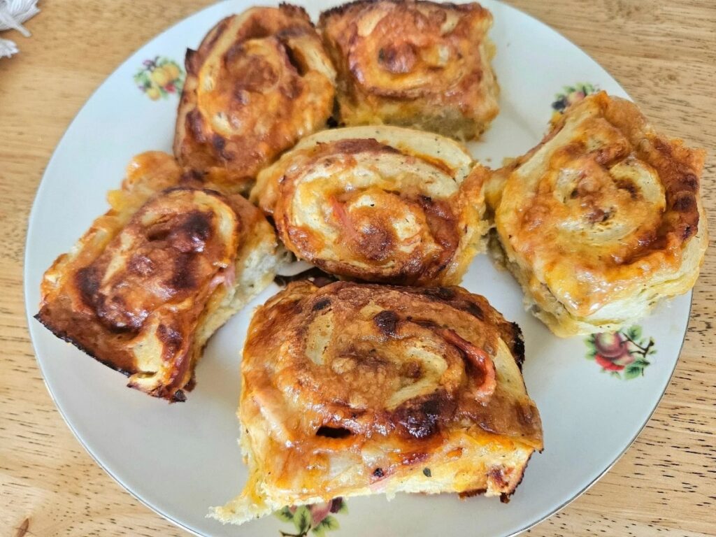 Homemade soft sourdough pizza rolls on a plate.