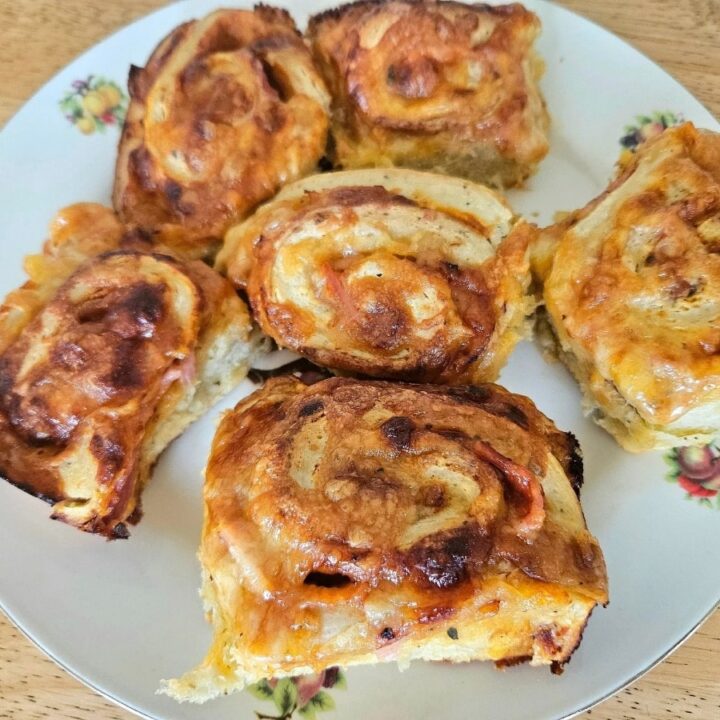 Homemade soft sourdough pizza rolls on a plate.