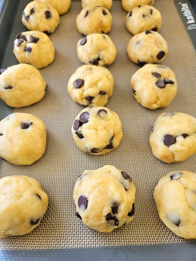 Sourdough cookie sough balls on a baking tray.