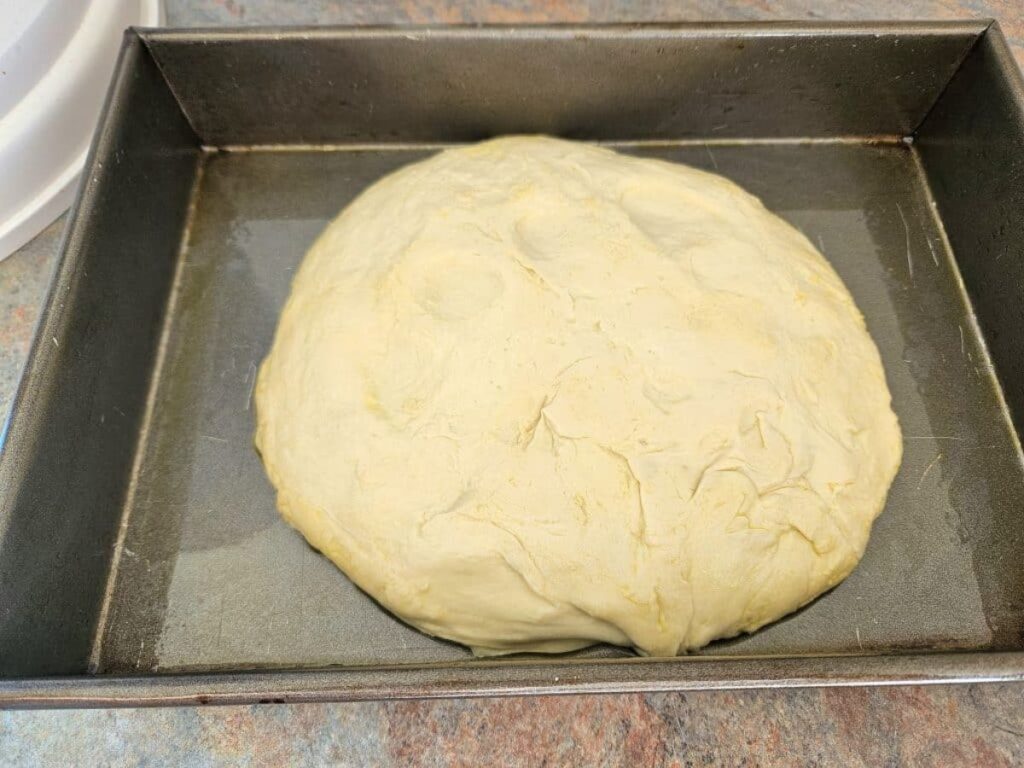 Sourdough focaccia dough resting in a tray.