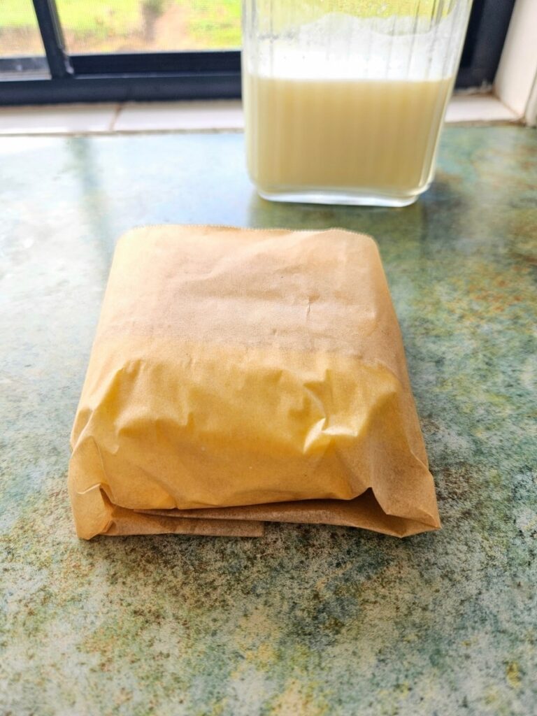 Storing butter in wax paper to freeze for later.