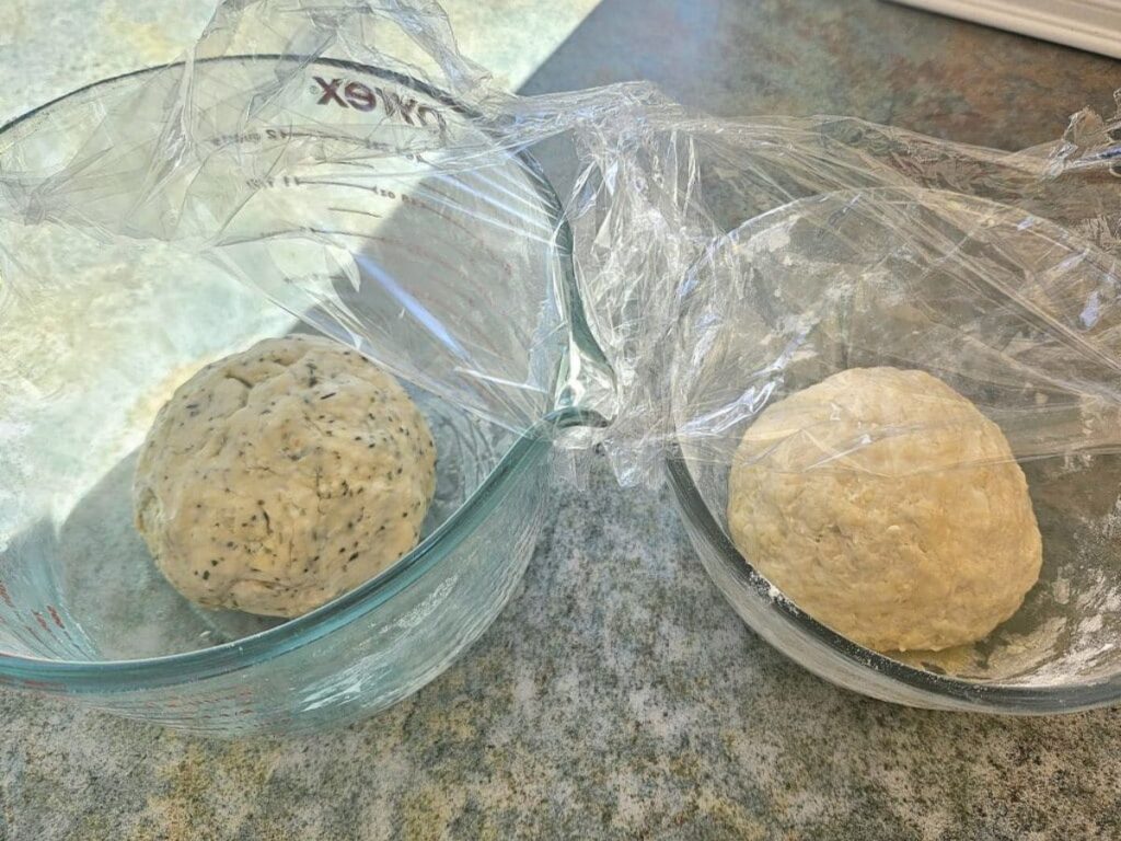 Sourdough cracker dough balls resting in bowls.