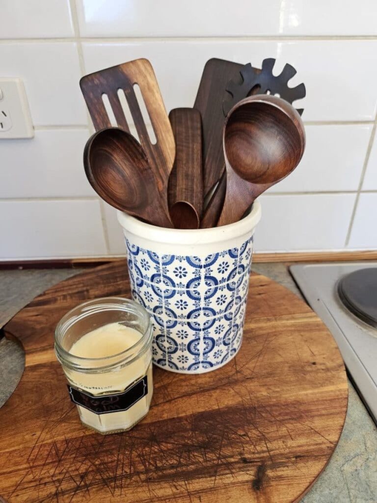 Wooden kitchen utensils in a container in the kitchen.