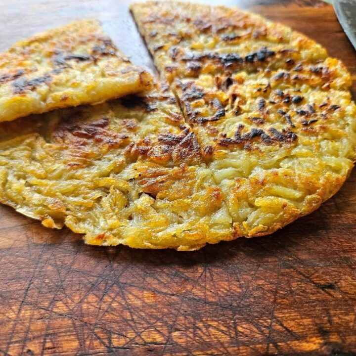 Crispy homemade hash brown on a cutting board.