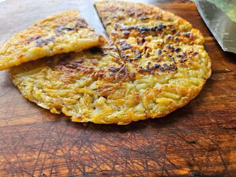 Crispy homemade hash brown on a cutting board.