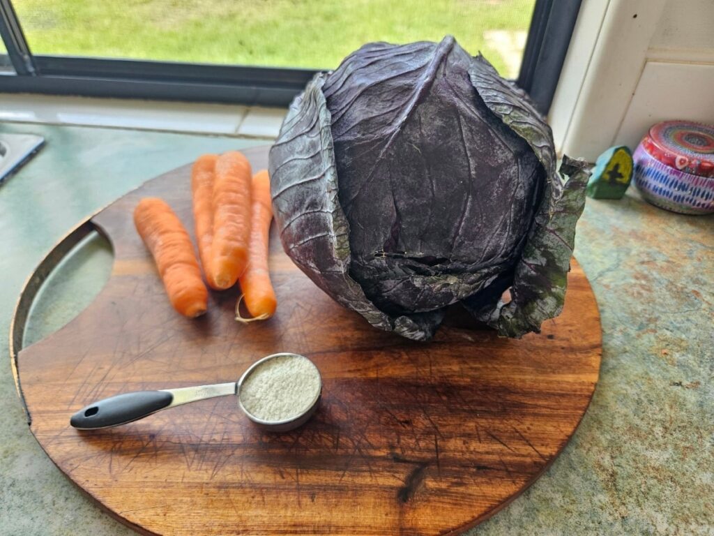 Sauerkraut ingredients on a cutting board.