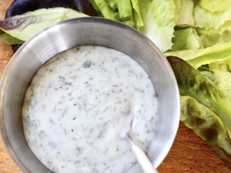 German salad dressing in a stainless-steel bowl being mixed up.