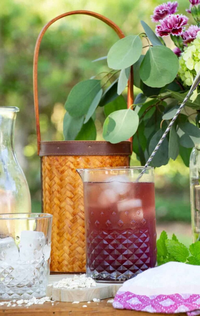 Herbal tea in a pitcher on a table outside.