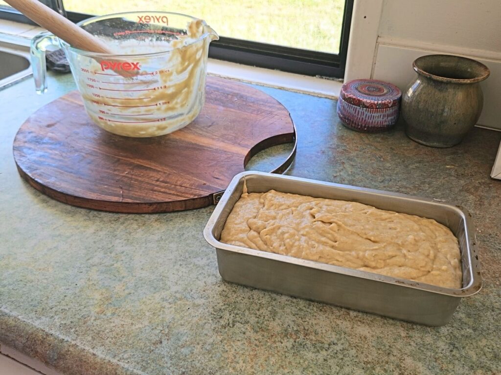 Banana bread mixture in a bread pan ready to be baked.